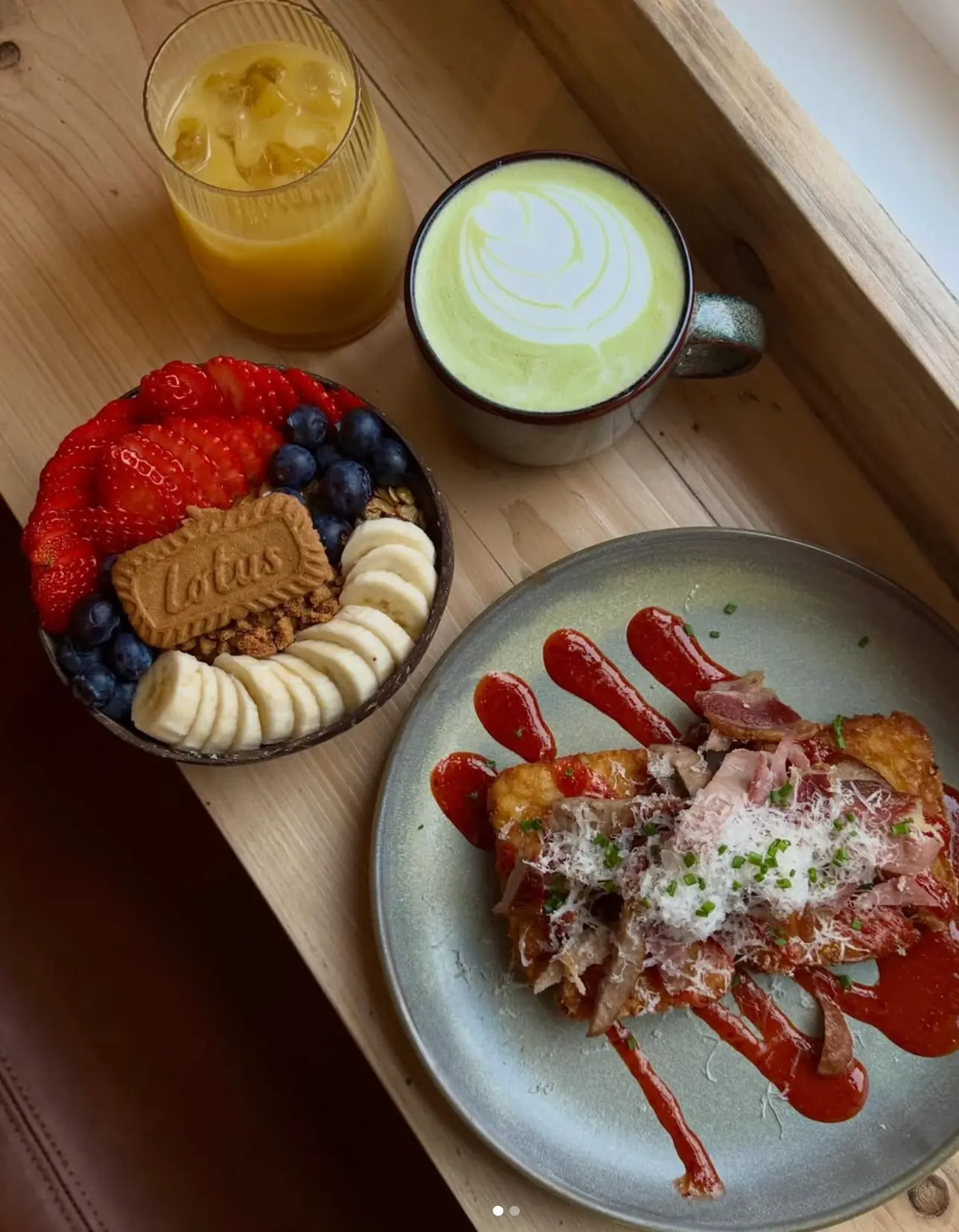 A loaded breakfast tray with hash, eggs, sausage and toast at Leaf + Bean