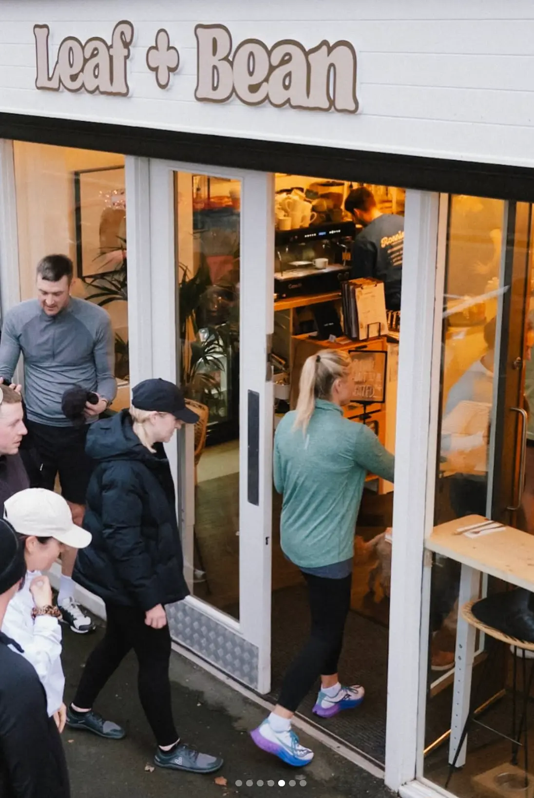 Customers heading into Leaf + Bean under the shop sign on Emmerson Terrace, Washington
